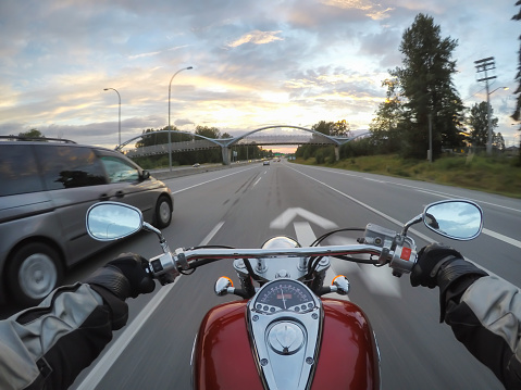 Riding a motorcycle during a vibrant sunset. Taken in Surrey, Greater Vancouver, British Columbia, Canada.