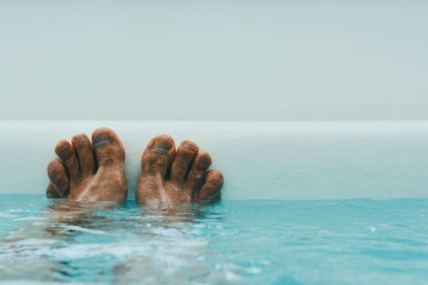Mans Feet in White Spa stock photo