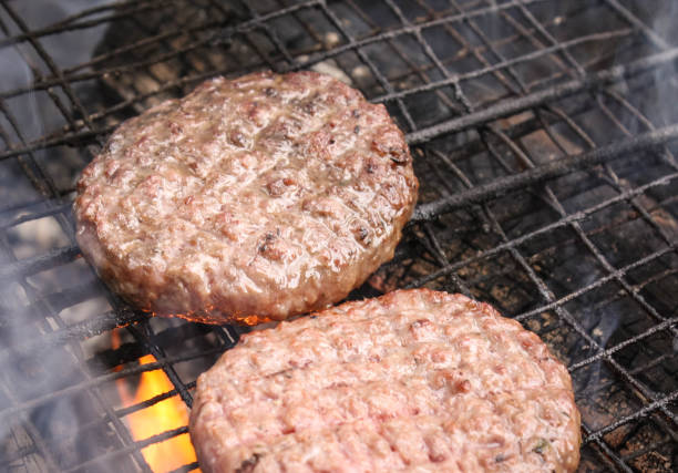 istock outdoors cooking burgers on hot grill with flames 1025226910