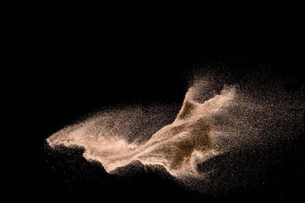 istock Dry river sand explosion. Golden colored sand splash agianst dark background. 1025229224