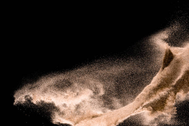 istock Dry river sand explosion. Golden colored sand splash agianst dark background. 1025229228