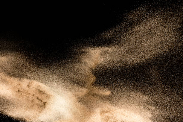 istock Dry river sand explosion. Golden colored sand splash agianst dark background. 1025229232