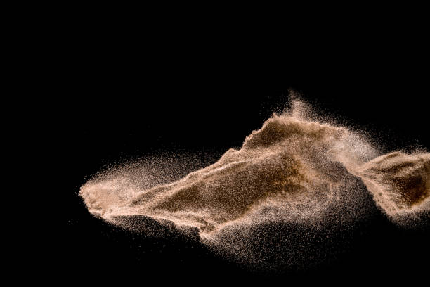 istock Dry river sand explosion. Golden colored sand splash agianst dark background. 1025229244
