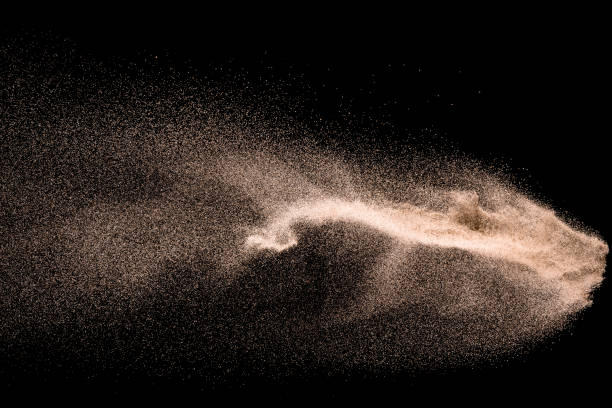 istock Dry river sand explosion. Golden colored sand splash agianst dark background. 1025229248