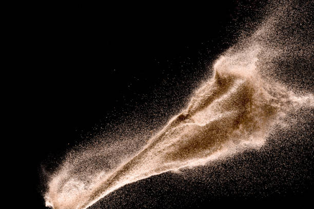 istock Dry river sand explosion. Golden colored sand splash agianst dark background. 1025229258