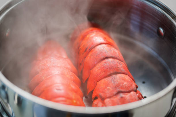 Steaming lobster tails in pot