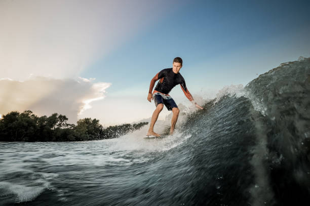 istock Active brunet man riding on the wakeboard 1025238336