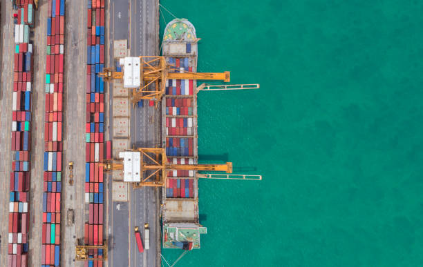 istock Aerial view ship container at commercial port for international import export or transportation concept background. 1025243692