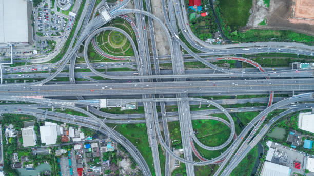 istock Aerial view highway road intersection at dusk for transportation, distribution or traffic background. 1025243748
