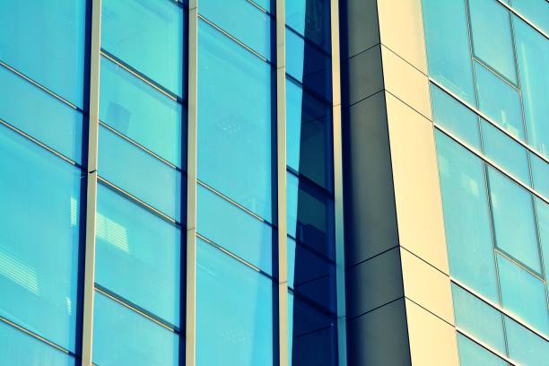 istock Modern office building on a clear sky background. Retro stylized colorful tonal filter effect 1025244456