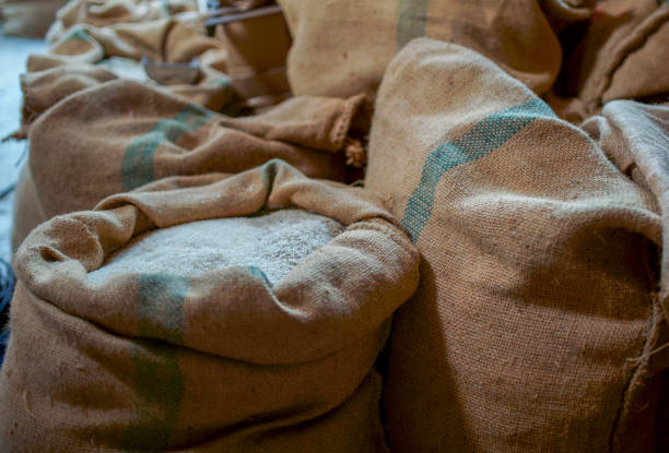 White rice in sackcloth isolated in the warehouse.
