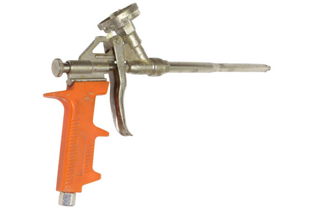 istock mounting foam gun with the orange plastic handle isolated on white background with clipping path 1025251788