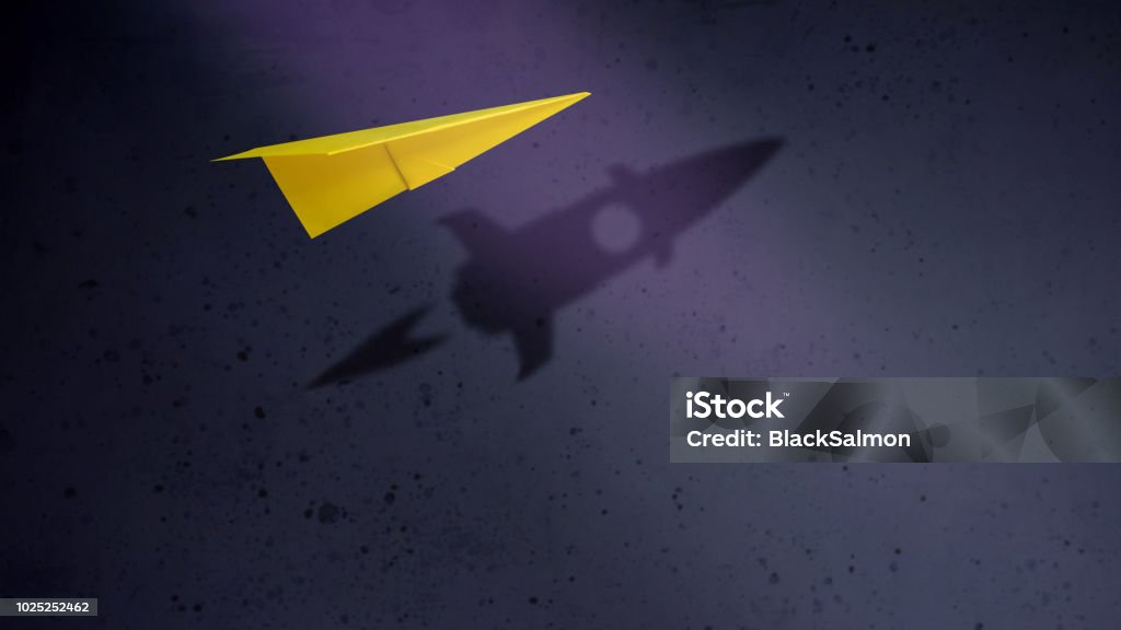 Start-up Company and Motivation in Business Concept. Paper Planes Flying with Shadow of Rocket over the Wall Change Stock Photo