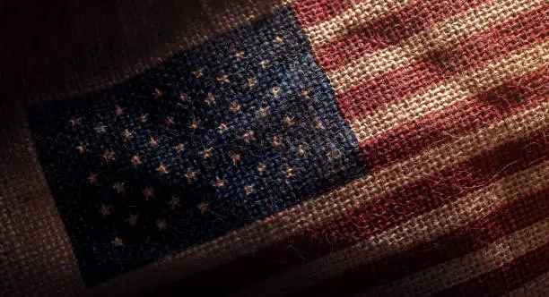 American USA Flag printed on Dark Grunge Burlap Sack , Closeup shot