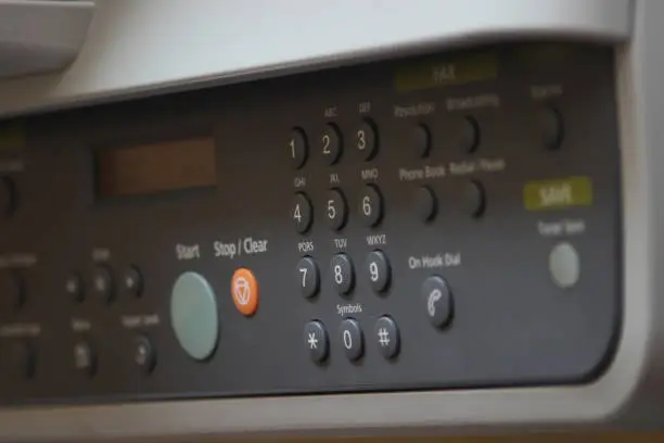Close up of the plastic controlpanel space of a Printer with buttons and commands