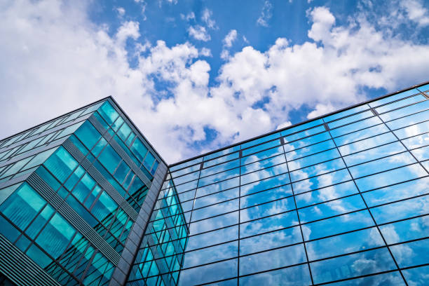 istock Glass Facade With Reflection Of Clouds 1025287052