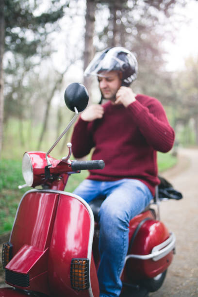istock Young hipster man in helmet sitting on a vintage scooter . 1025302784
