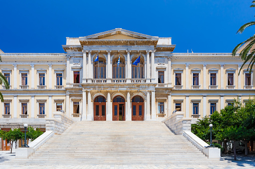 ERMOUPOLIS - JULY 2017: The Town Hall of Syros in Miaouli Square, Greece. It was designed by Ernst Ziller and is one of the most beautiful neoclassical buildings in Syros