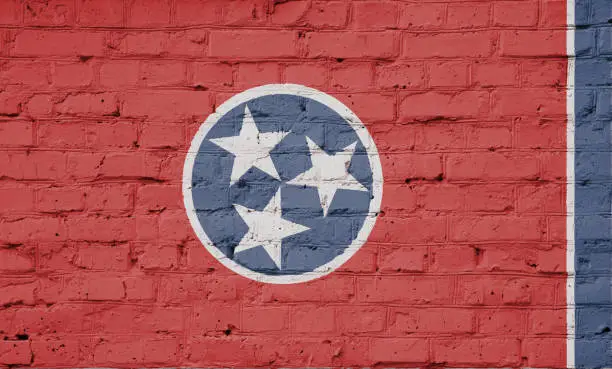Texture of a flag of Tennessee  on a pink brick wall.