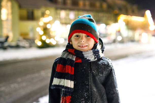 istock Happy kid boy having fun with snow in winter 1025312486