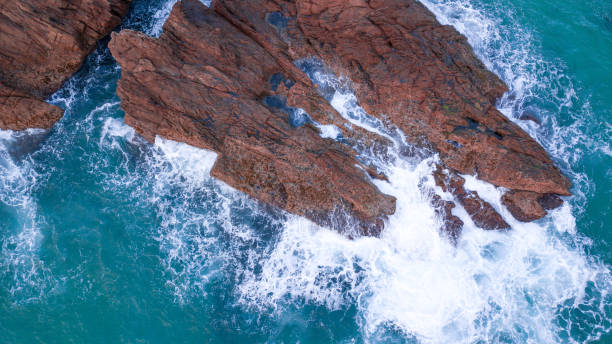 istock sea crashing on rocks 1025313810