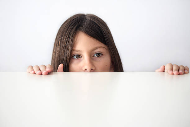 istock Child looks out from under the table 1025321870
