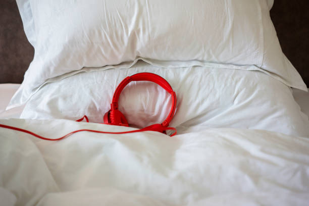 red earphone on bed stock photo