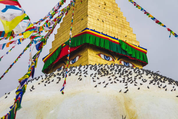 Famous Buddhist Shrine Boudhanath Stupa with Prayer Flags and Pigeons in Kathmandu Nepal,is one of the largest stupas in the world.Boudhanath Stupa is also a UNESCO World Heritage Site.