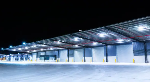 Illuminated exterior of a factory, industrial style building. Night time.Illuminated exterior of a factory, industrial style building. Night time.