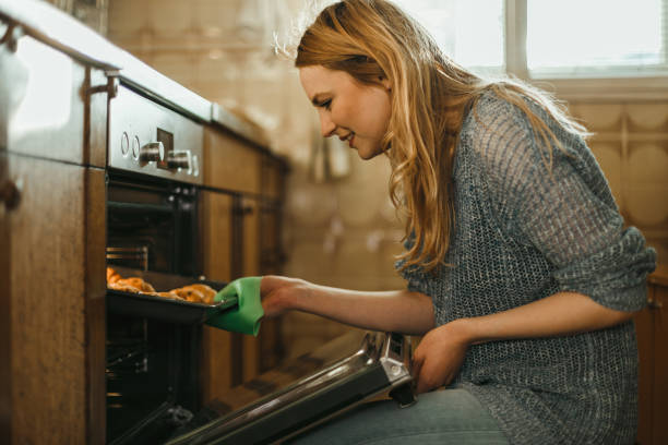 istock Beautiful young woman baking pastries in the kitchen 1025372220