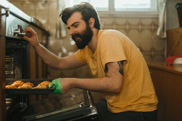 istock Handsome man baking pastries in the kitchen 1025372746