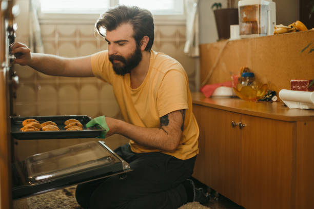 istock Handsome man baking pastries in the kitchen 1025372756