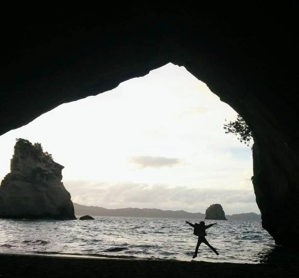 istock Girl silhouette by the cove 1025372844