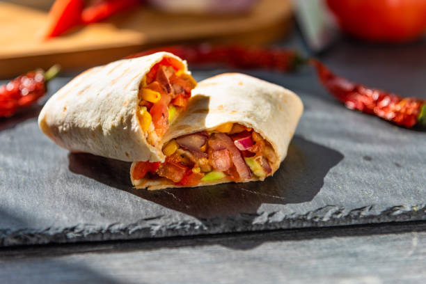 istock Traditional Mexican burrito on a serving board closeup 1025386230