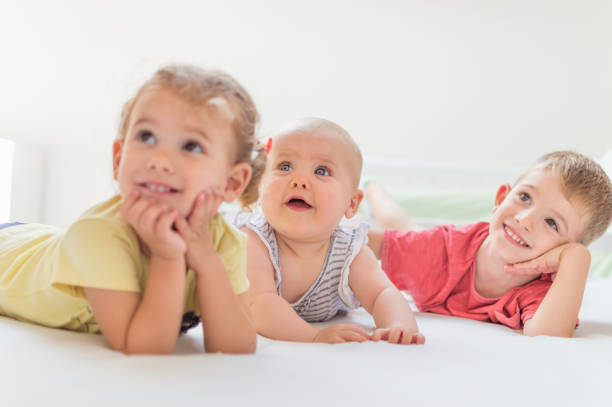 istock Three kids playing in bedroom 1025398860