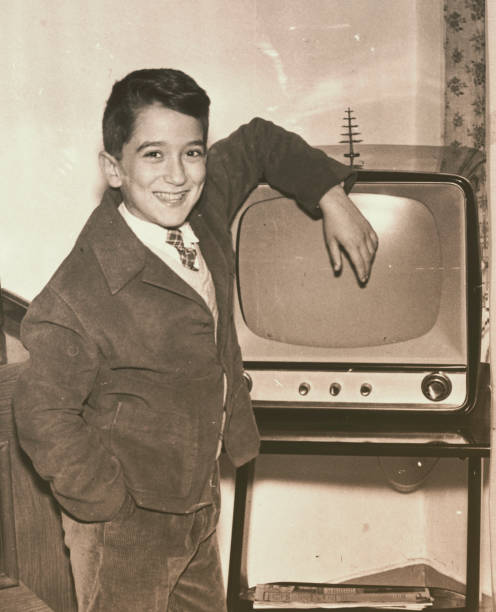 1957 young boy with television - children tv 1950s imagens e fotografias de stock