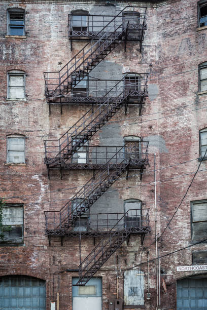 istock Worn brick building with metal fire escape 1025413826