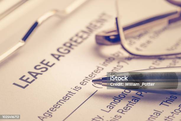 Business Legal Document Concept Pen And Glasses On A Lease Agreement Form Lease Agreement Is A Contract Between A Lessor And A Lessee That Allow Lessee Rights To Use Of A Property Owned By Lessor Stock Photo - Download Image Now