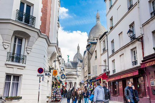 PARIS, FRANCE - MARCH, 2018: People walking around the famous Montmartre neighborhood in a beautiful winter day