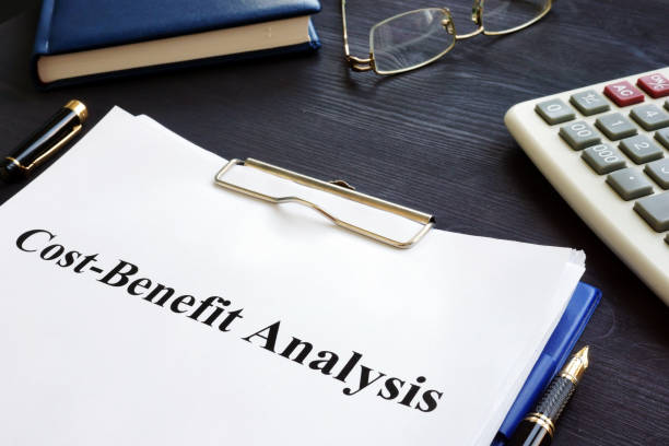 istock Cost Benefit Analysis CBA and pen on a desk. 1025425646