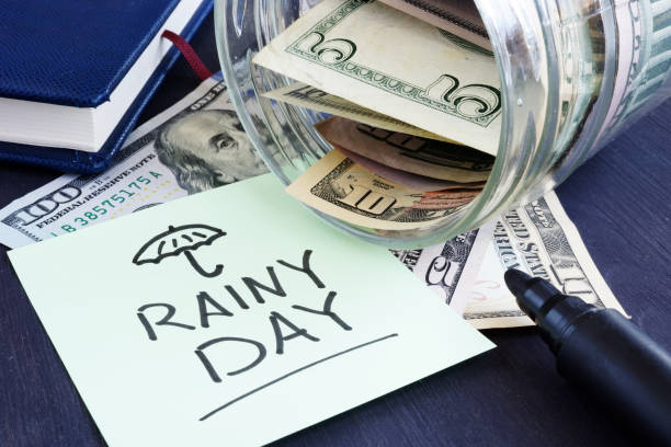 istock Rainy day fund savings. Jar with dollar bills. 1025426254