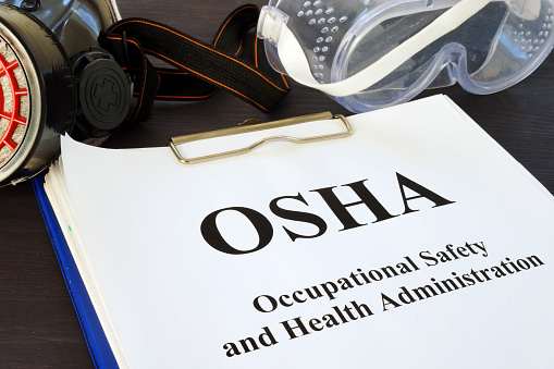 Pila de documentos con la Occupational Safety and Health Administration OSHA. photo