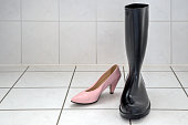Black rubber boots and pink pumps.