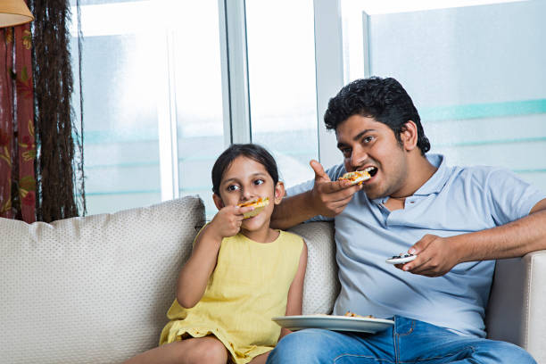 istock Dad and daughter cooking - Stock image 1025436028