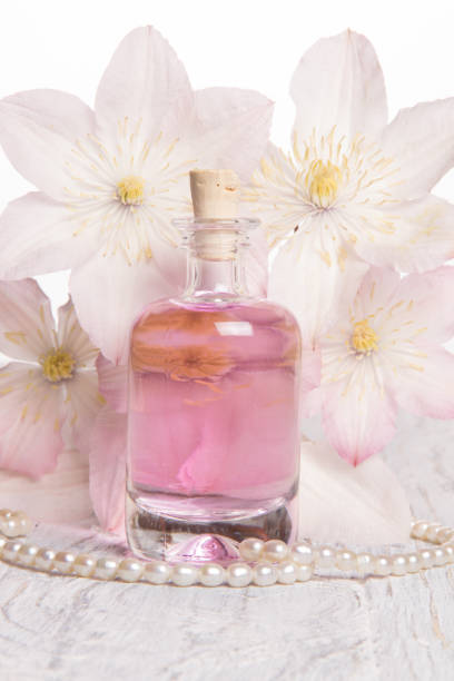 istock Perfume bottle and white flowers 1025438730