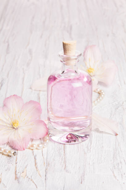 istock Perfume bottle and white flowers 1025438782