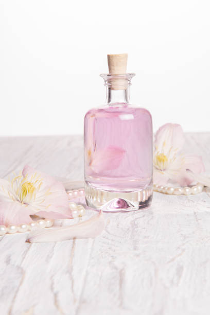 istock Perfume bottle and white flowers 1025438898