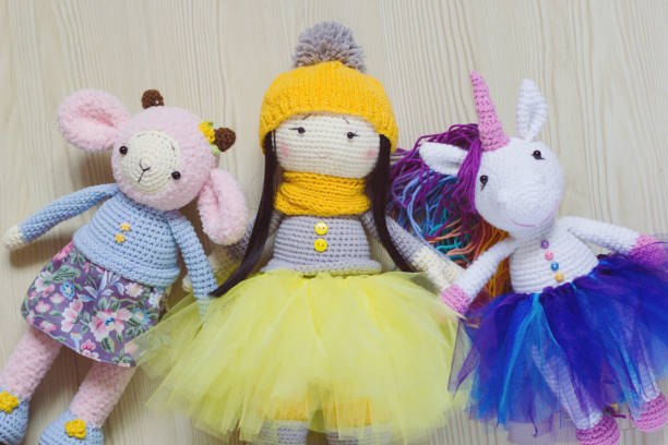 istock Three knitted toys: a sheep, a unicorn and a doll. 1025439416
