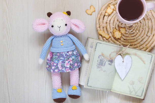 istock Knitted pink sheep in blue clothes. 1025439472