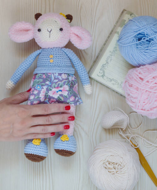 istock Knitted pink sheep in blue clothes. 1025440738